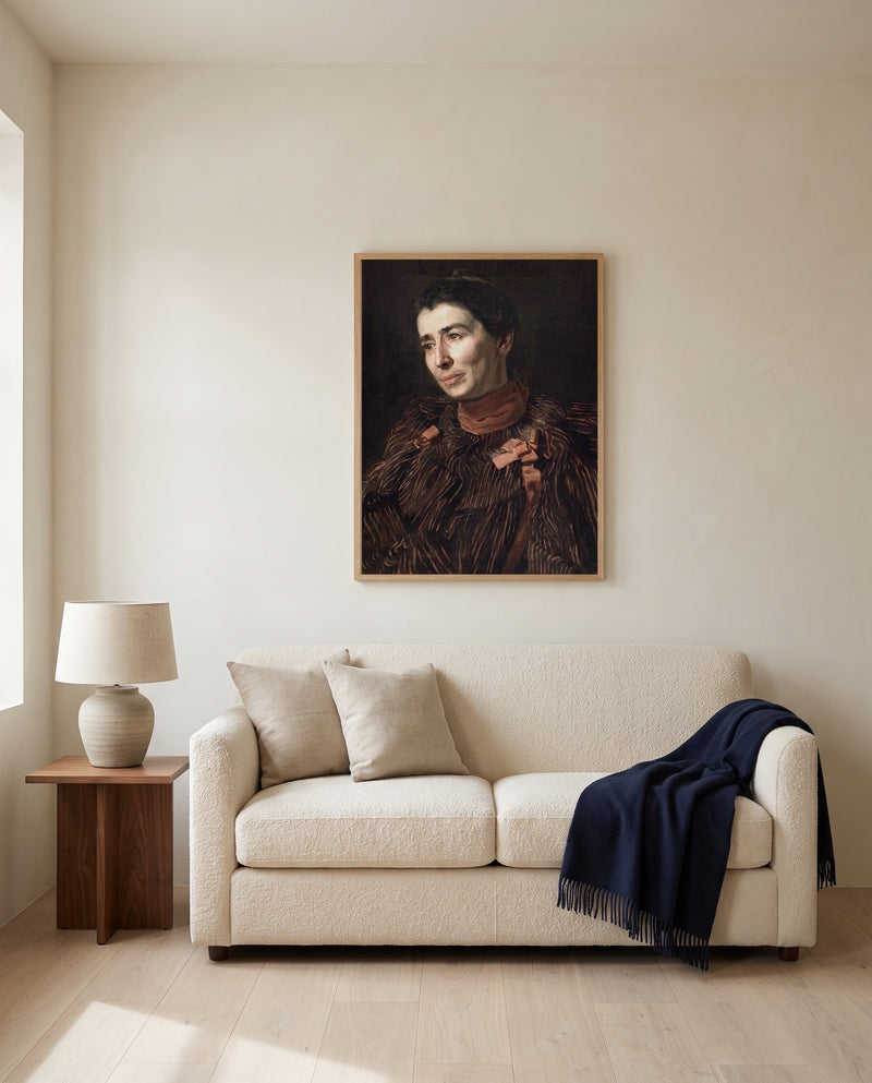 Mary Adeline Williams by Thomas Eakins framed in natural oak above a cream sofa in a warm living room