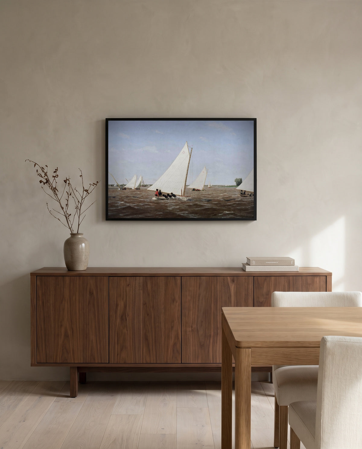 Sailboats Racing by Thomas Eakins in a black frame above a walnut sideboard in a dining room