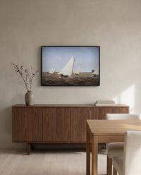 Sailboats Racing by Thomas Eakins in a black frame above a walnut sideboard in a dining room