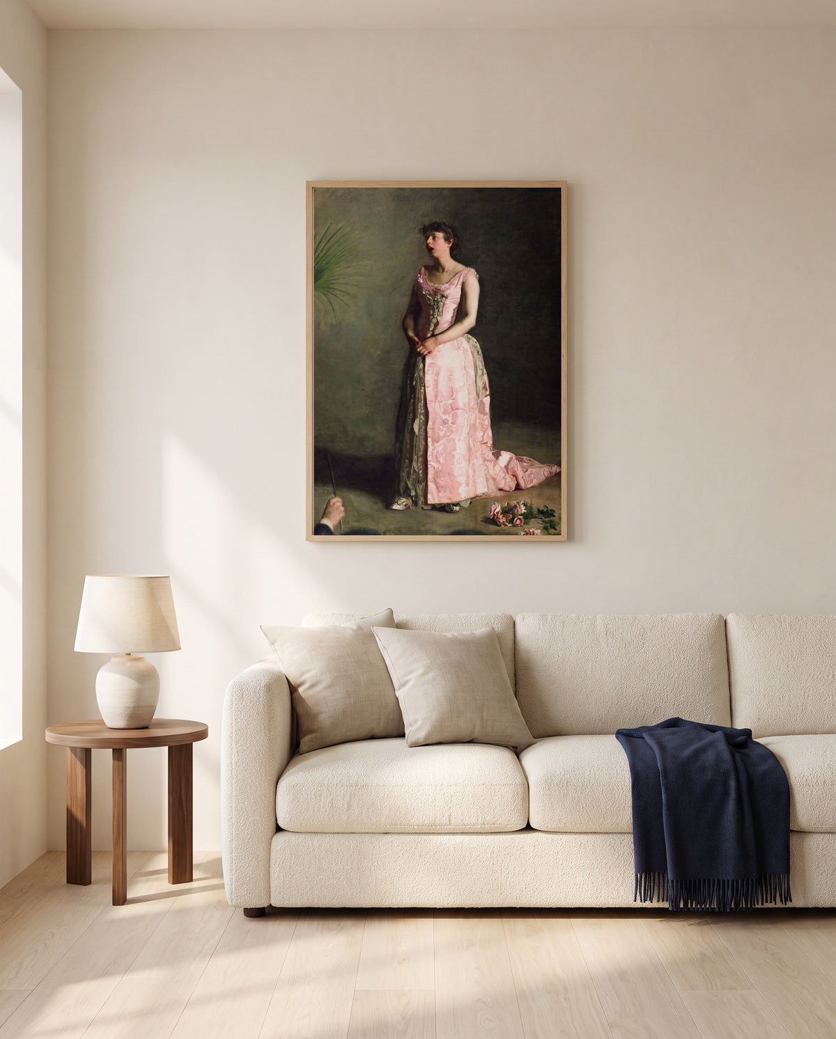 The Concert Singer by Thomas Eakins framed in natural oak above a cream sofa in a warm living room