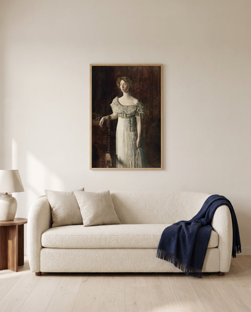 The Old-Fashioned Dress by Thomas Eakins framed in natural oak above a cream sofa in a warm living room