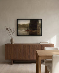 The Pair-Oared Shell by Thomas Eakins in a black frame above a walnut sideboard in a dining room