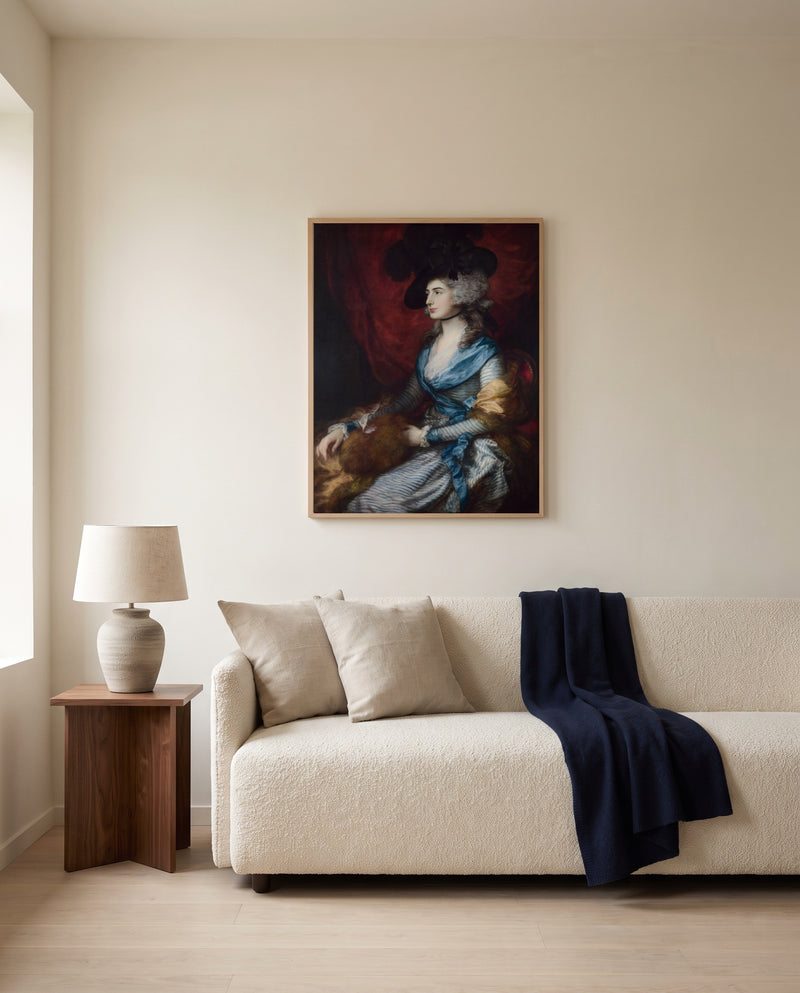 Mrs Siddons by Thomas Gainsborough framed in natural oak above a cream sofa in a warm living room
