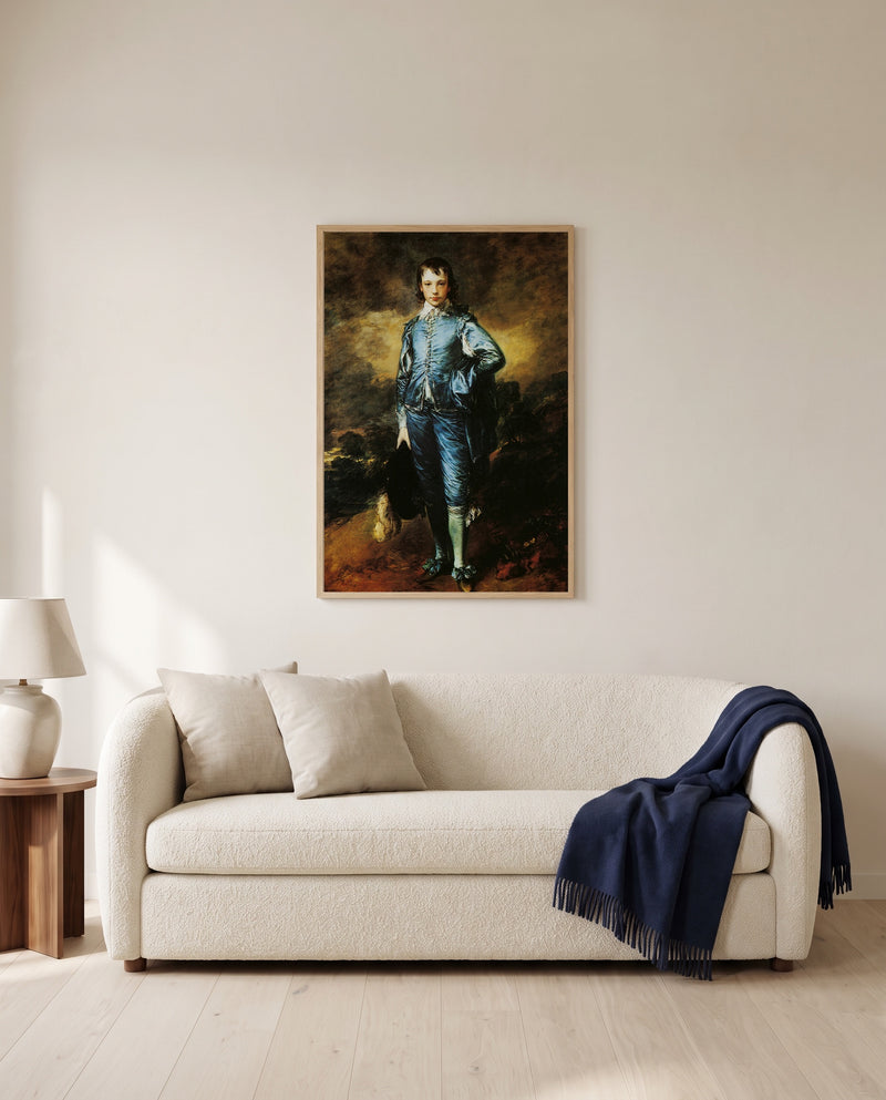 The Blue Boy by Thomas Gainsborough framed in natural oak above a cream sofa in a warm living room