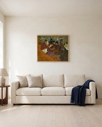 At the Moulin Rouge by Henri de Toulouse-Lautrec framed in natural oak above a cream sofa in a warm living room