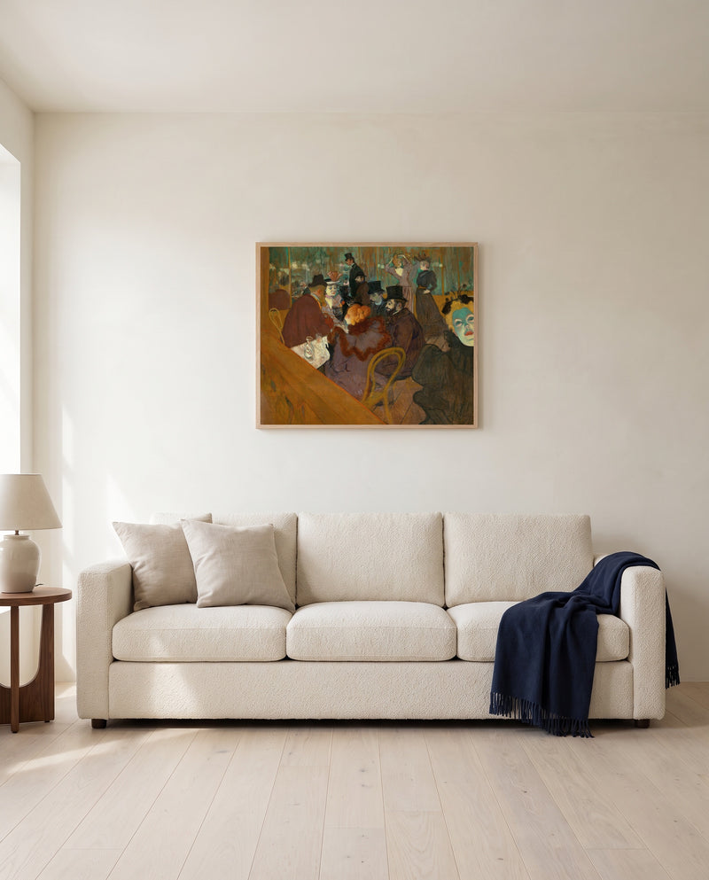 At the Moulin Rouge by Henri de Toulouse-Lautrec framed in natural oak above a cream sofa in a warm living room