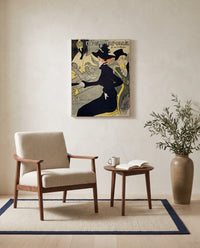 Divan Japonais by Henri de Toulouse-Lautrec as a stretched canvas above a linen lounge chair in a reading corner