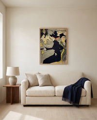 Divan Japonais by Henri de Toulouse-Lautrec framed in natural oak above a cream sofa in a warm living room