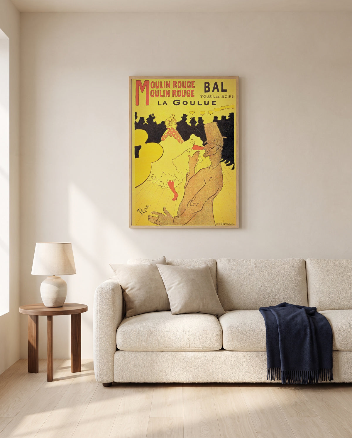 Moulin Rouge: La Goulue by Henri de Toulouse-Lautrec framed in natural oak above a cream sofa in a warm living room