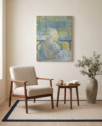 Portrait of Van Gogh by Henri de Toulouse-Lautrec as a stretched canvas above a linen lounge chair in a reading corner