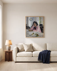 Girl with Peaches by Valentin Serov framed in natural oak above a cream sofa in a warm living room