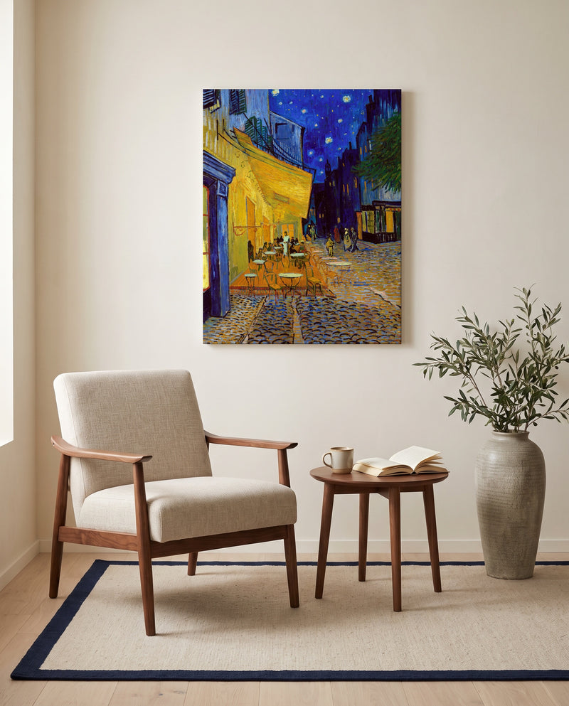 Café Terrace at Night by Vincent van Gogh as a stretched canvas above a linen lounge chair in a reading corner