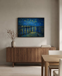 Starry Night Over the Rhône by Vincent van Gogh in a black frame above a walnut sideboard in a dining room