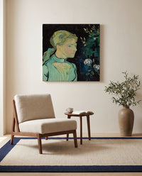 Adeline Ravoux by Vincent van Gogh as a stretched canvas above a linen lounge chair in a reading corner