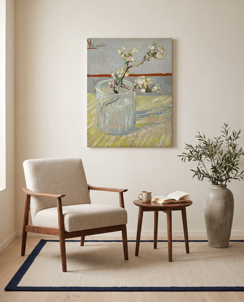 Almond Branch in a Glass by Vincent van Gogh as a stretched canvas above a linen lounge chair in a reading corner