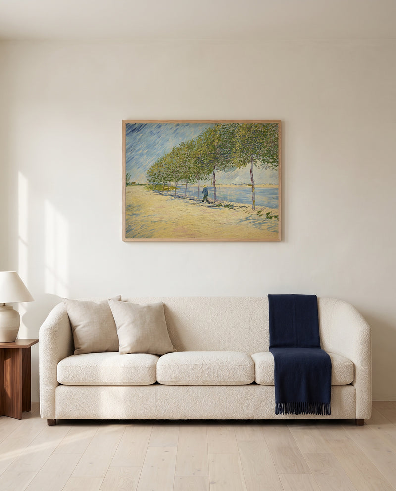 Along the Seine by Vincent van Gogh framed in natural oak above a cream sofa in a warm living room