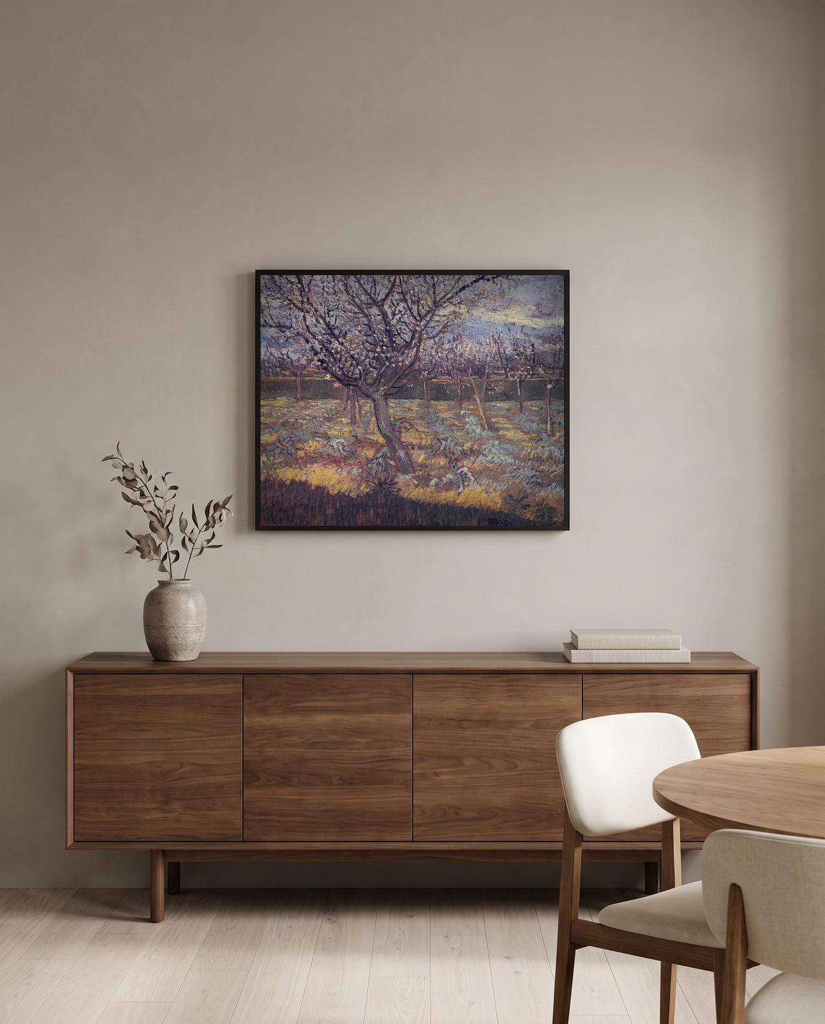 Apricot Trees in Blossom by Vincent van Gogh in a black frame above a walnut sideboard in a dining room