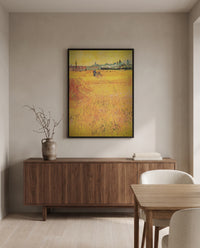 Arles: View from the Wheat Fields by Vincent van Gogh in a black frame above a walnut sideboard in a dining room