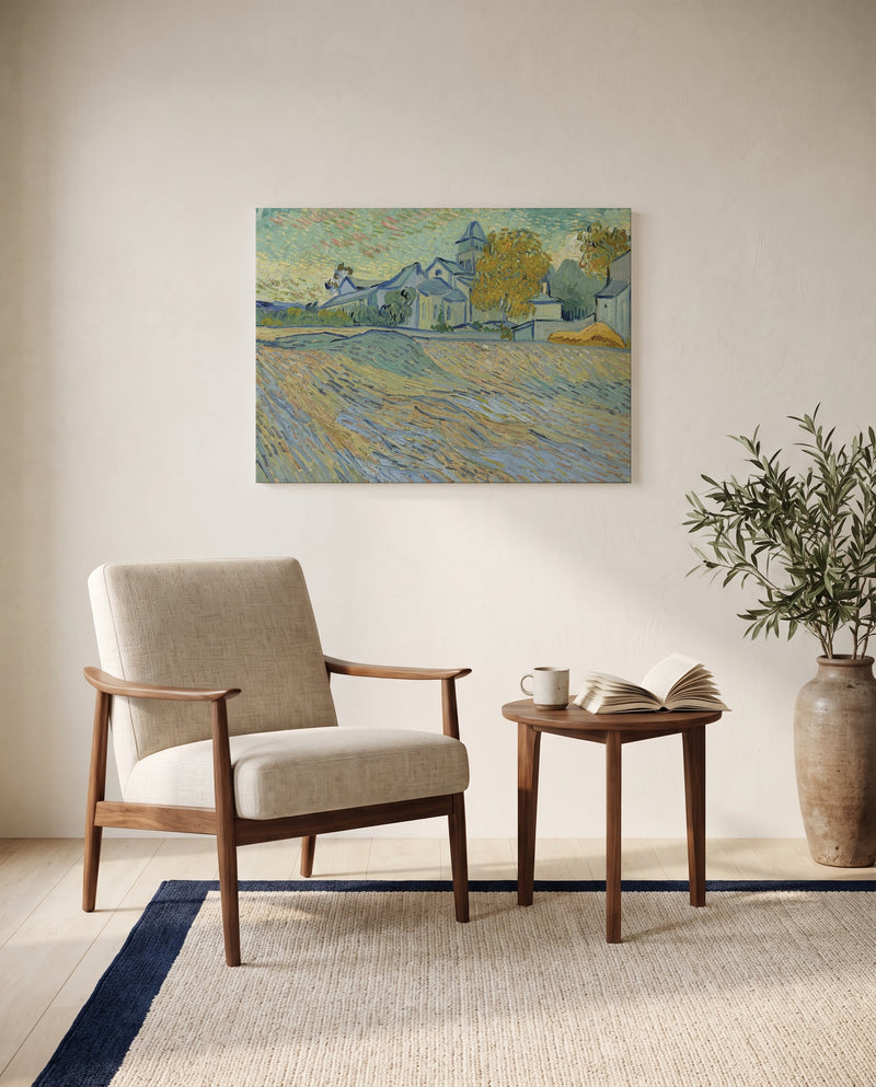 Asylum and Chapel of Saint-Rémy by Vincent van Gogh as a stretched canvas above a linen lounge chair in a reading corner