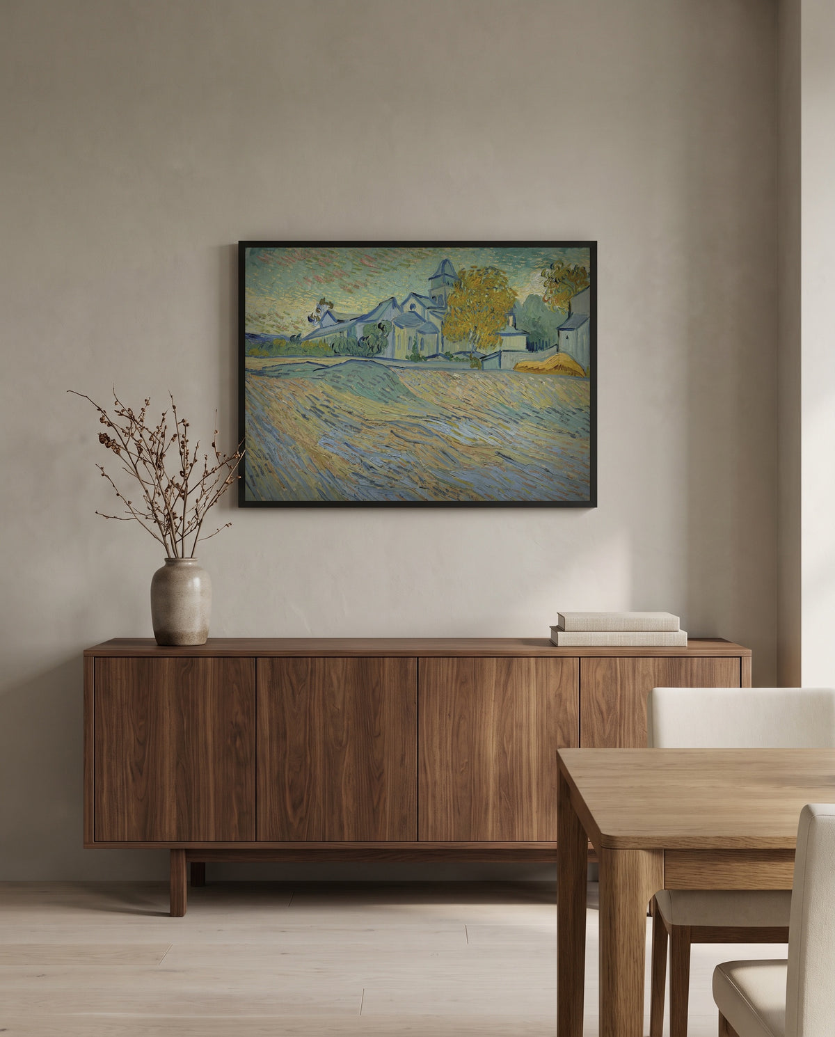 Asylum and Chapel of Saint-Rémy by Vincent van Gogh in a black frame above a walnut sideboard in a dining room