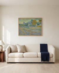 Asylum and Chapel of Saint-Rémy by Vincent van Gogh framed in natural oak above a cream sofa in a warm living room