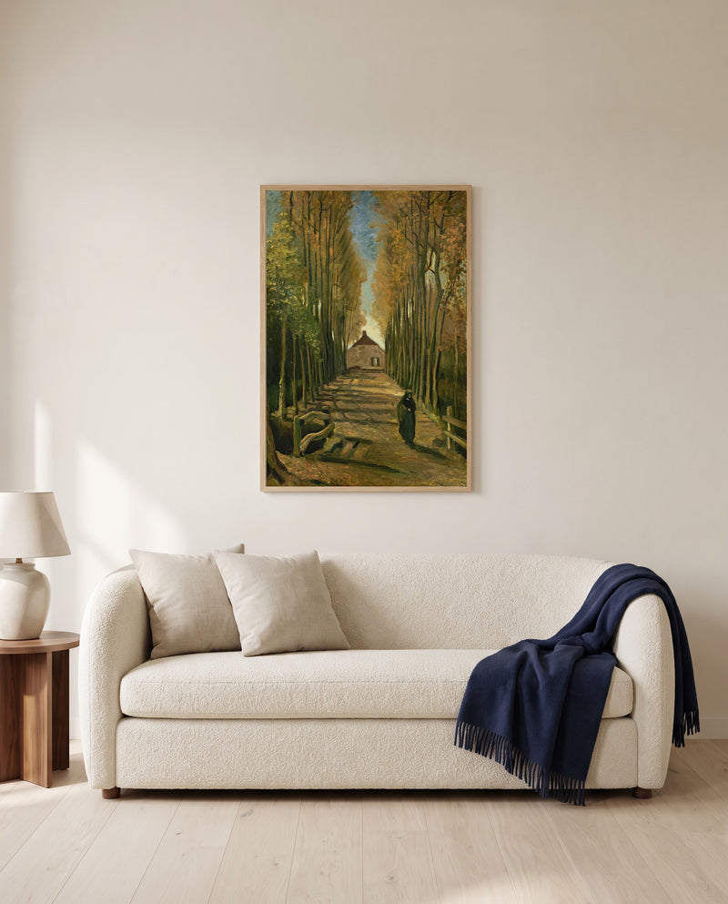 Avenue of Poplars in Autumn by Vincent van Gogh framed in natural oak above a cream sofa in a warm living room