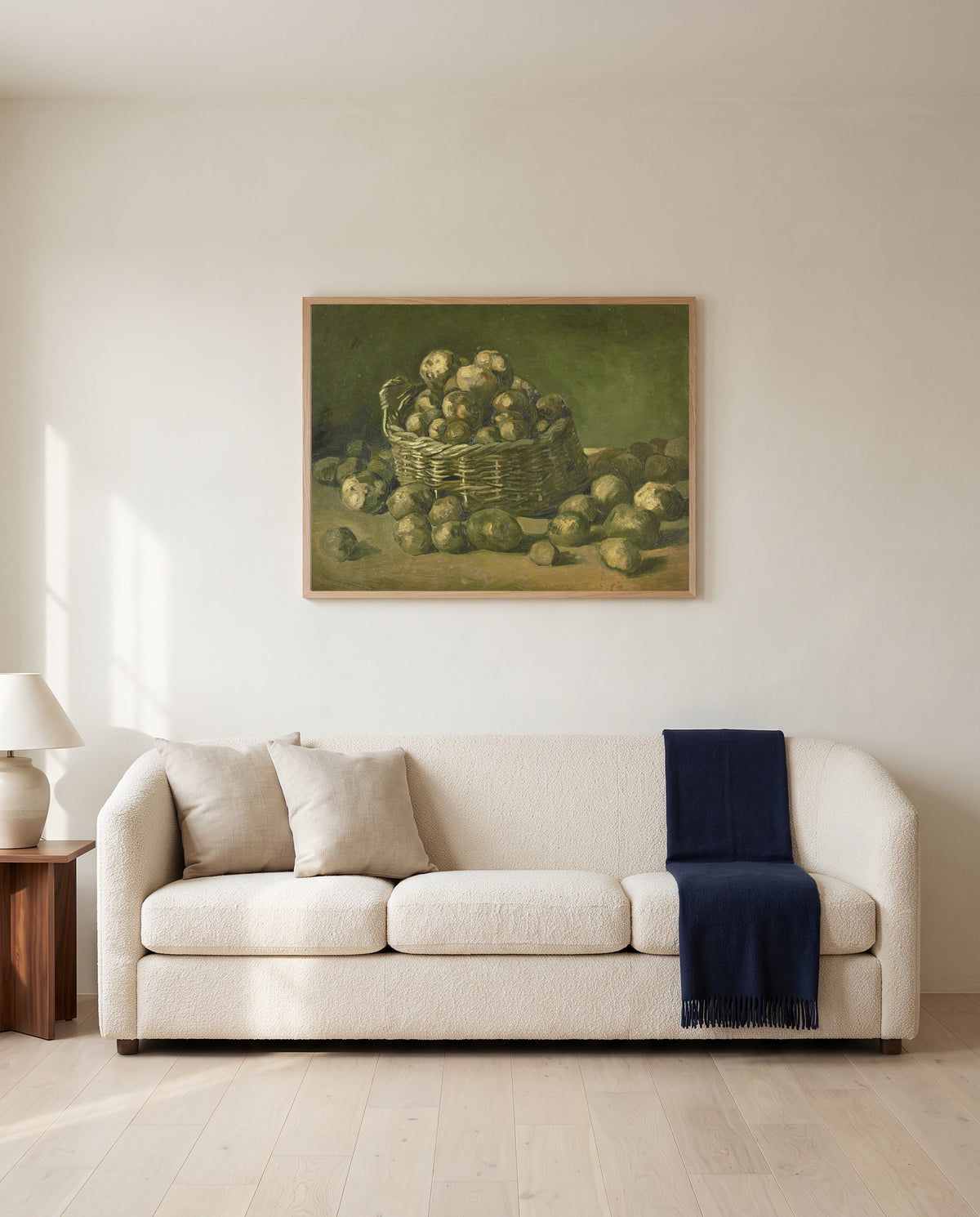 Basket of Potatoes by Vincent van Gogh framed in natural oak above a cream sofa in a warm living room