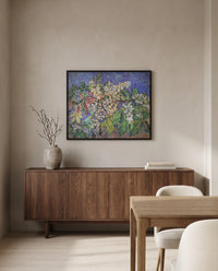 Blossoming Chestnut Branches by Vincent van Gogh in a black frame above a walnut sideboard in a dining room
