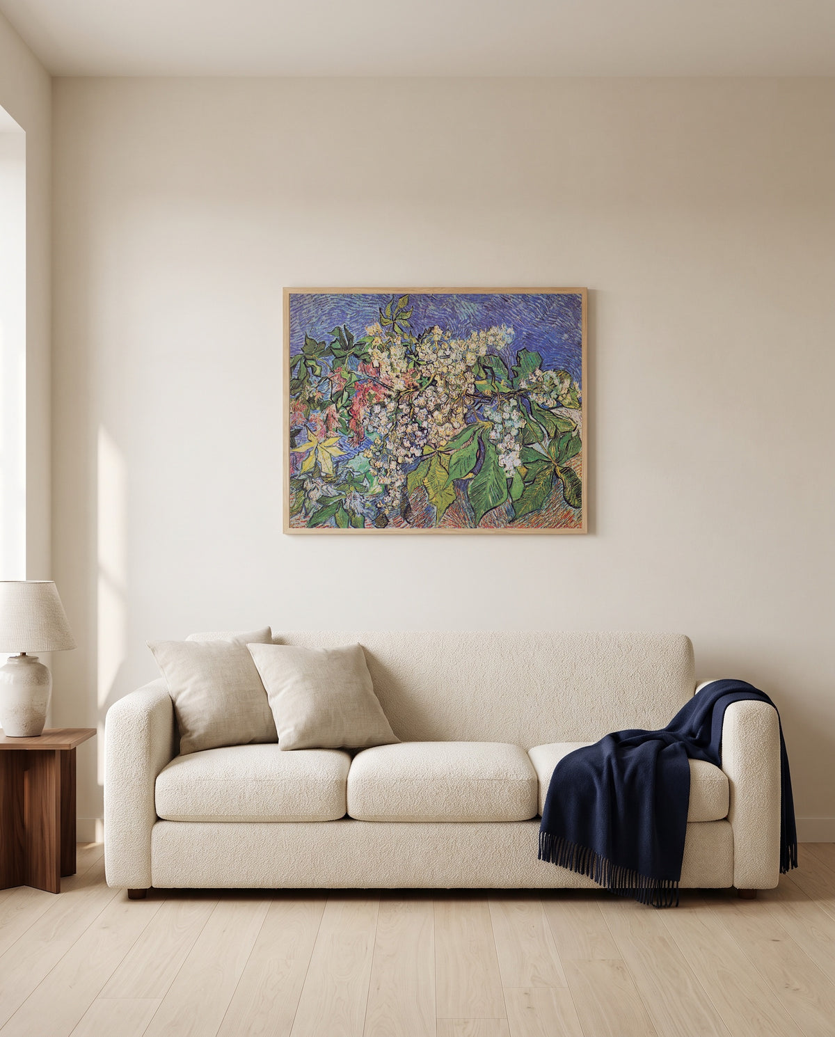 Blossoming Chestnut Branches by Vincent van Gogh framed in natural oak above a cream sofa in a warm living room