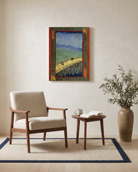 Bridge in the Rain by Vincent van Gogh as a stretched canvas above a linen lounge chair in a reading corner