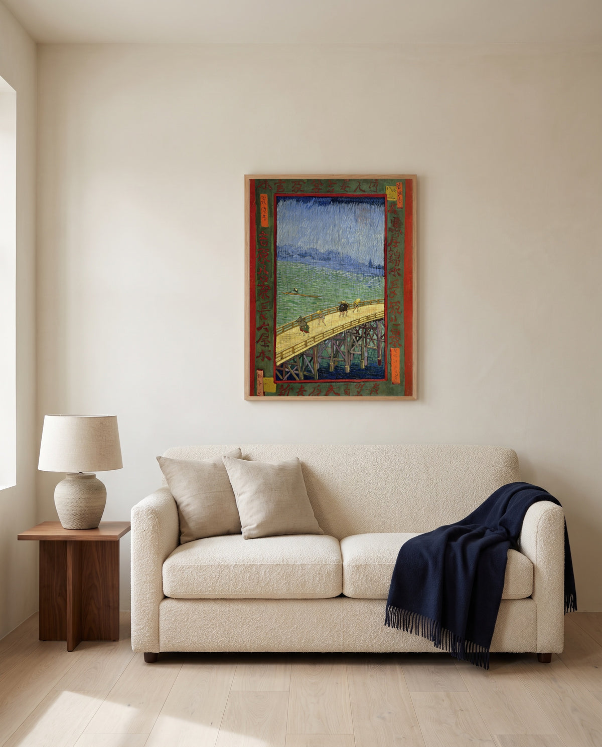 Bridge in the Rain by Vincent van Gogh framed in natural oak above a cream sofa in a warm living room