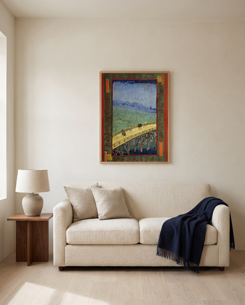 Bridge in the Rain by Vincent van Gogh framed in natural oak above a cream sofa in a warm living room