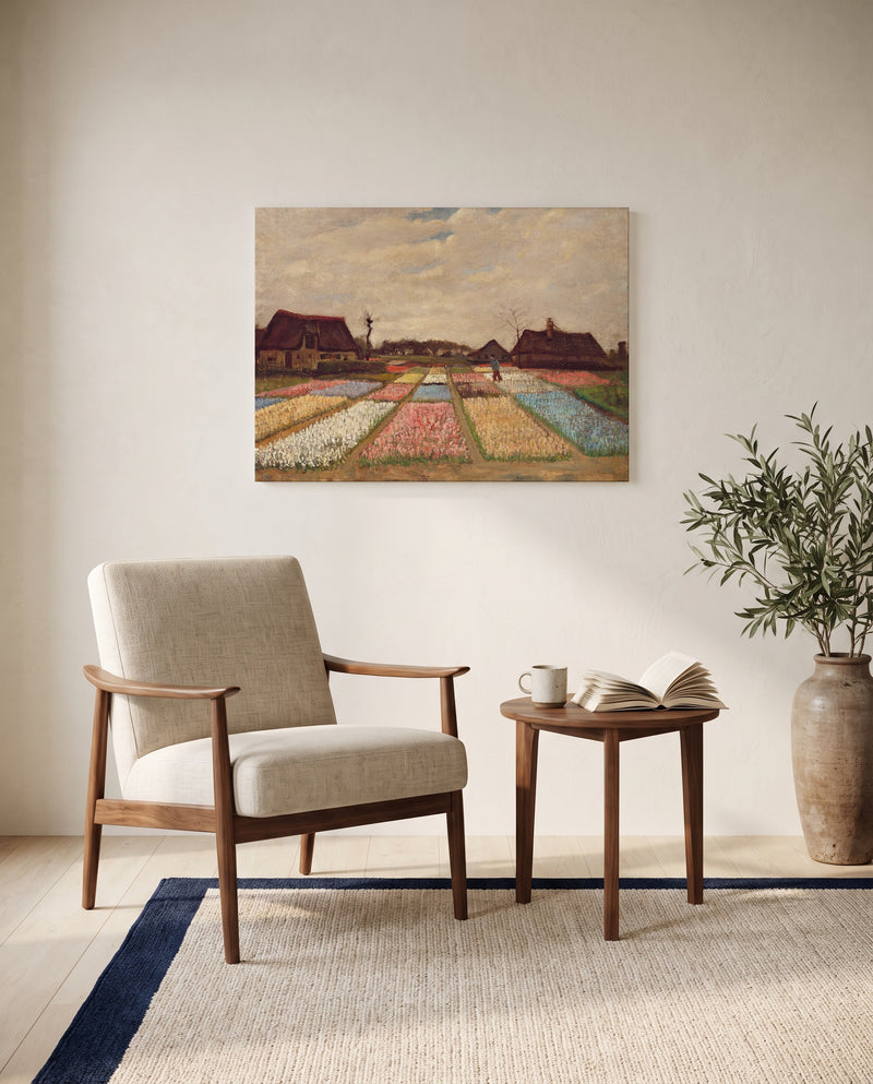 Bulb Fields by Vincent van Gogh as a stretched canvas above a linen lounge chair in a reading corner
