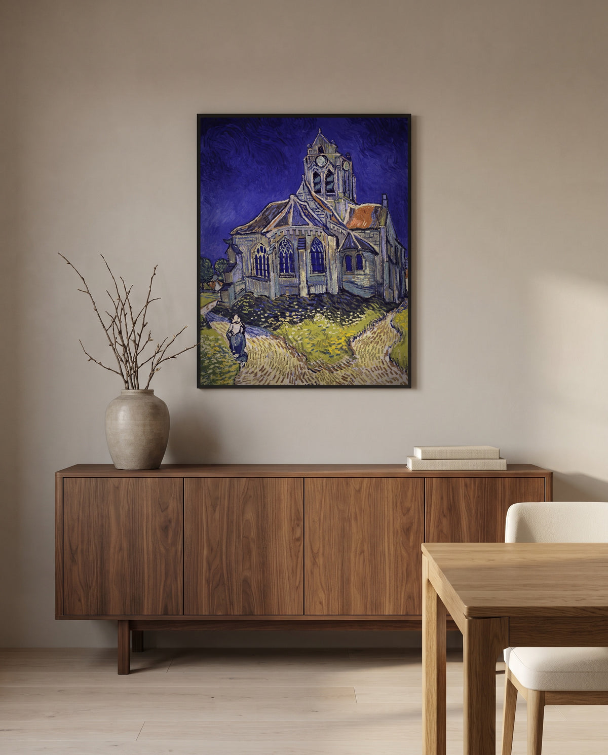 The Church at Auvers by Vincent van Gogh in a black frame above a walnut sideboard in a dining room
