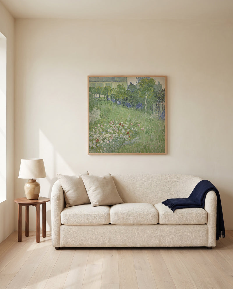 Daubigny’s Garden by Vincent van Gogh framed in natural oak above a cream sofa in a warm living room