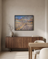 Enclosed Field with Peasant by Vincent van Gogh in a black frame above a walnut sideboard in a dining room