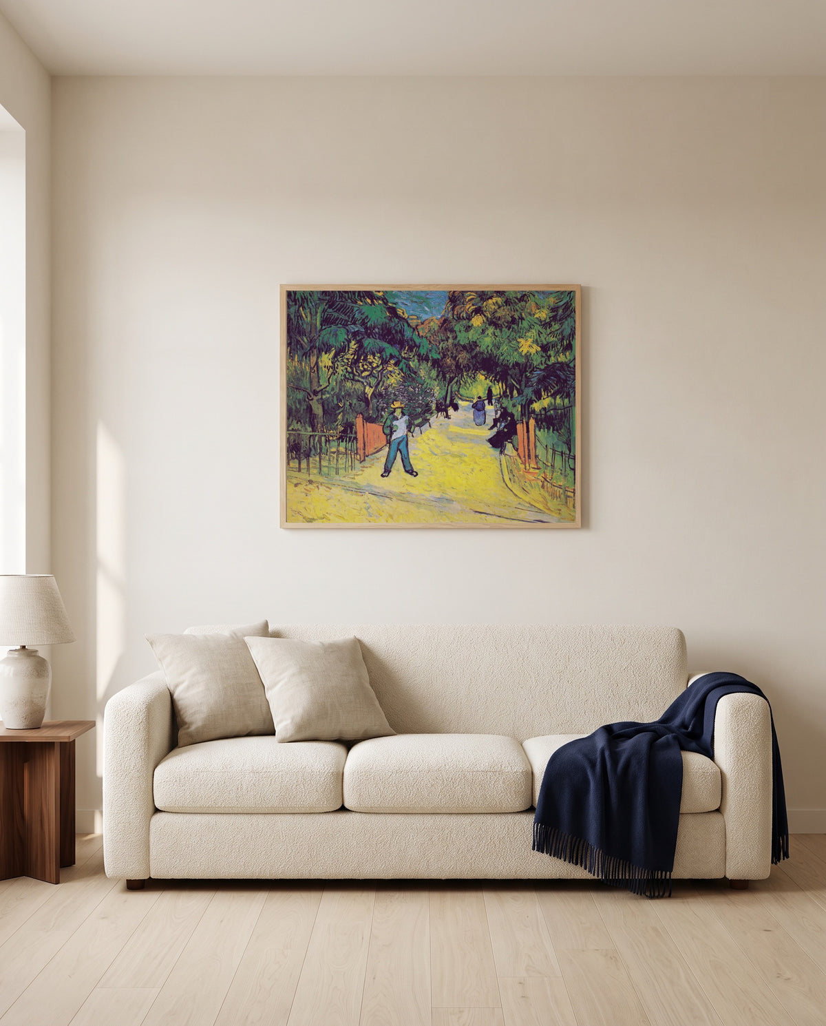 Entrance to the Public Park by Vincent van Gogh framed in natural oak above a cream sofa in a warm living room