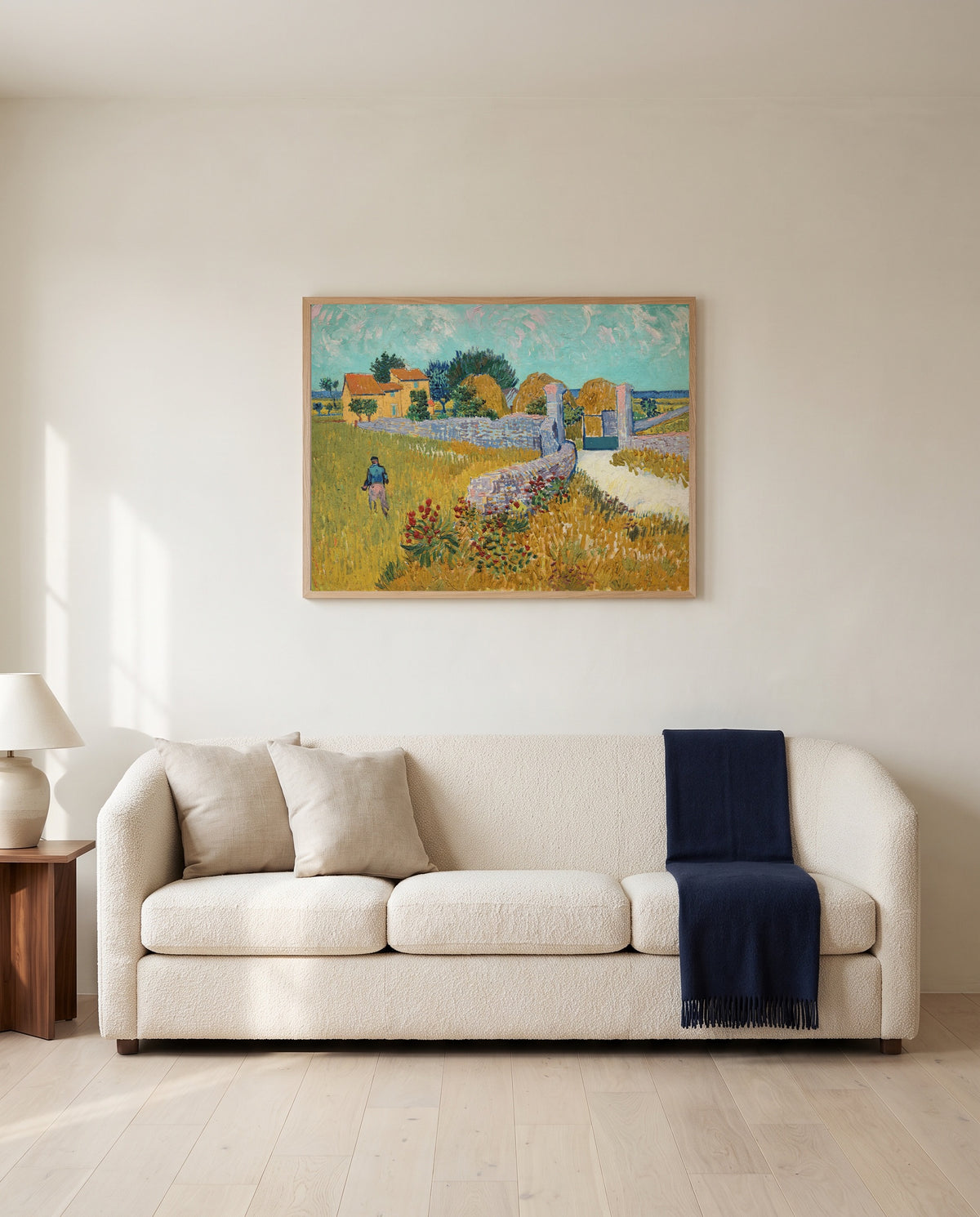 Farmhouse in Provence by Vincent van Gogh framed in natural oak above a cream sofa in a warm living room