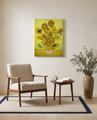 Fifteen Sunflowers by Vincent van Gogh as a stretched canvas above a linen lounge chair in a reading corner
