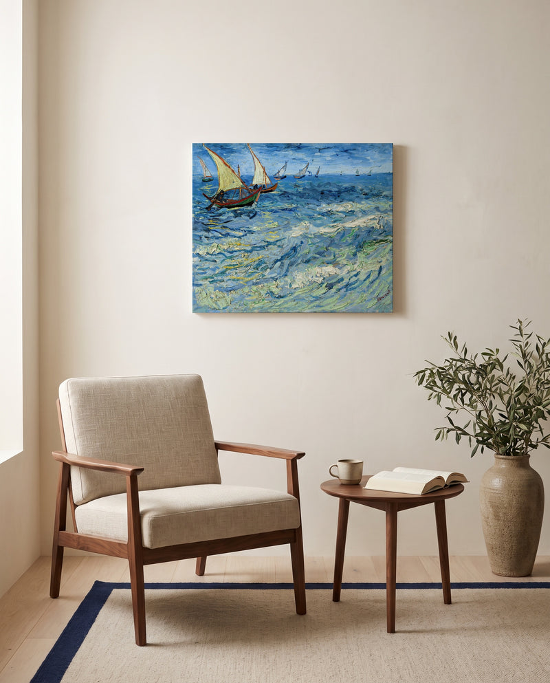 Fishing Boats at Sea by Vincent van Gogh as a stretched canvas above a linen lounge chair in a reading corner