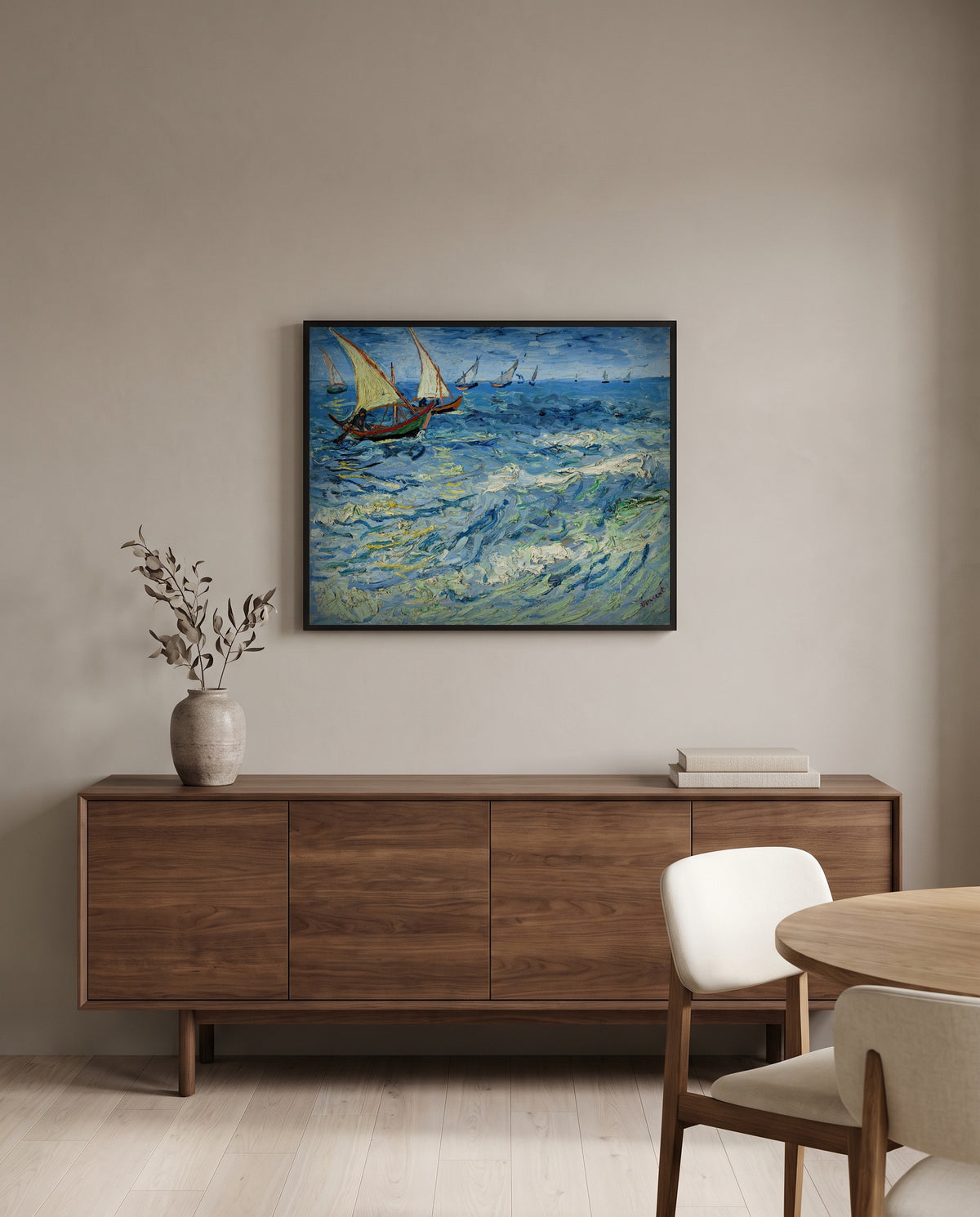 Fishing Boats at Sea by Vincent van Gogh in a black frame above a walnut sideboard in a dining room