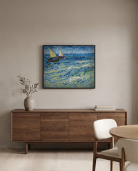 Fishing Boats at Sea by Vincent van Gogh in a black frame above a walnut sideboard in a dining room