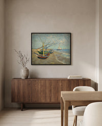 Fishing Boats on the Beach by Vincent van Gogh in a black frame above a walnut sideboard in a dining room