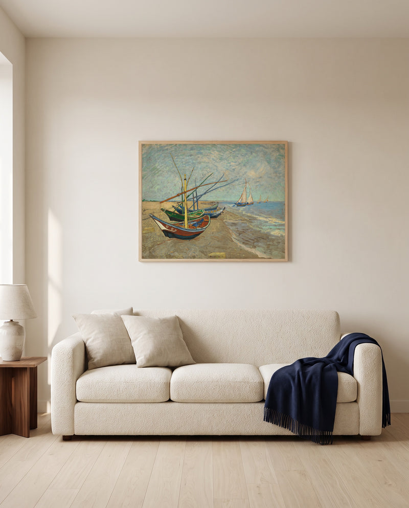Fishing Boats on the Beach by Vincent van Gogh framed in natural oak above a cream sofa in a warm living room
