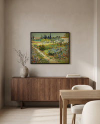 Flowering Garden with Path by Vincent van Gogh in a black frame above a walnut sideboard in a dining room