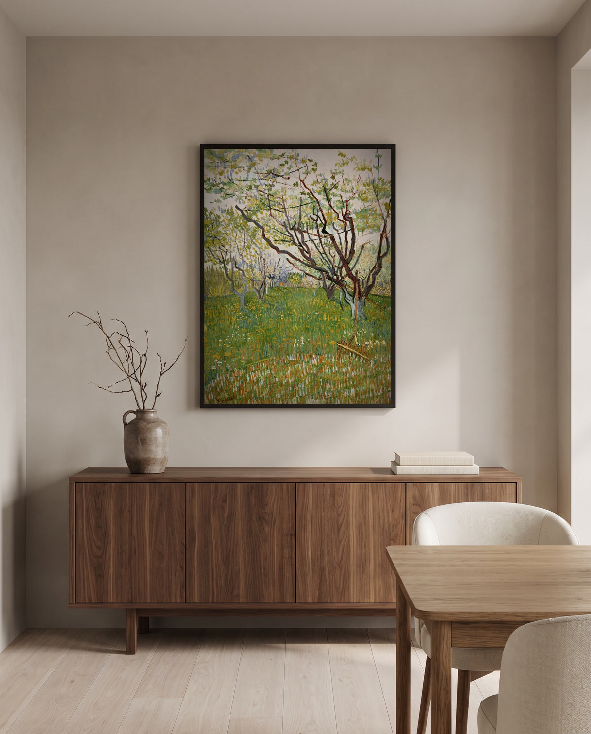 The Flowering Orchard by Vincent van Gogh in a black frame above a walnut sideboard in a dining room