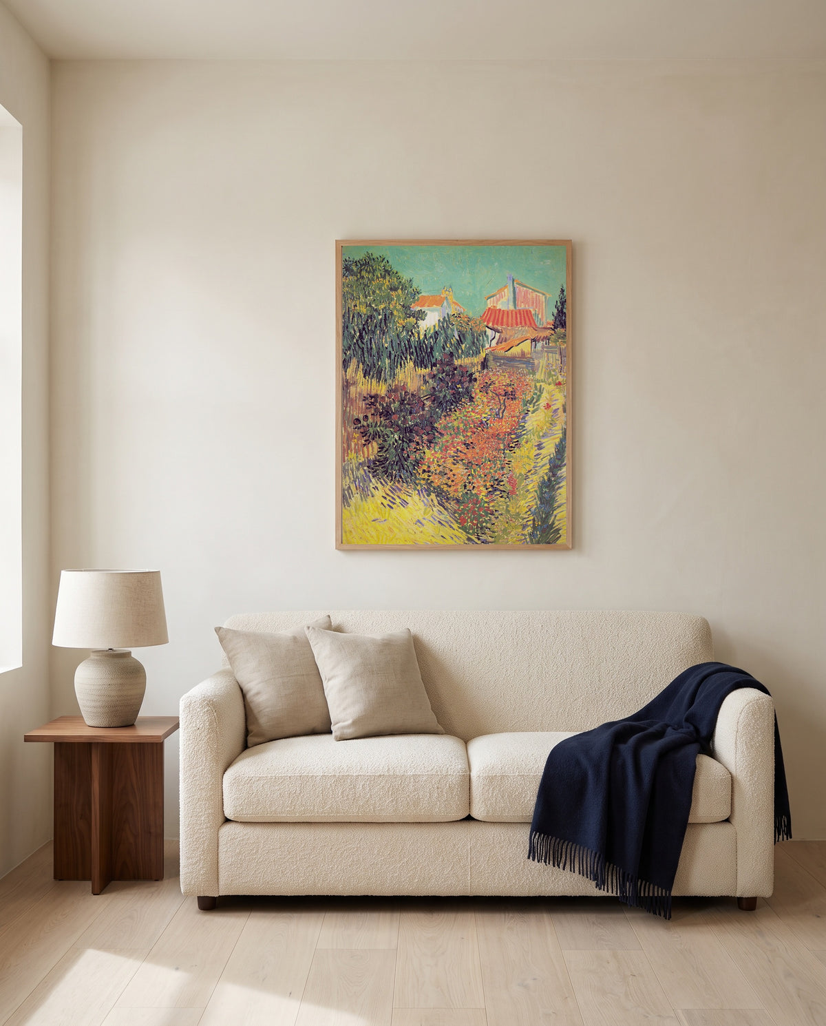 Garden Behind a House by Vincent van Gogh framed in natural oak above a cream sofa in a warm living room