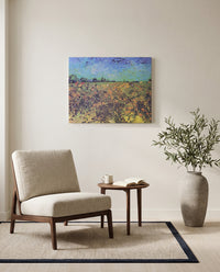 The Green Vineyard by Vincent van Gogh as a stretched canvas above a linen lounge chair in a reading corner