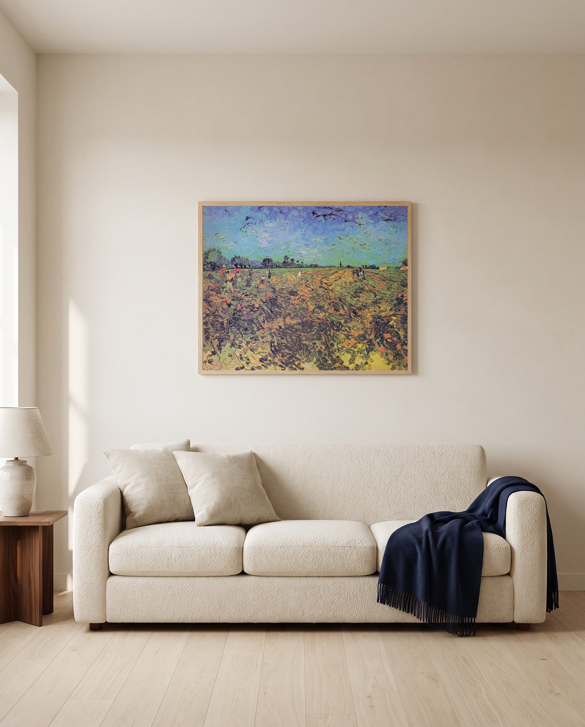 The Green Vineyard by Vincent van Gogh framed in natural oak above a cream sofa in a warm living room