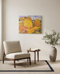 Haystacks in Provence by Vincent van Gogh as a stretched canvas above a linen lounge chair in a reading corner